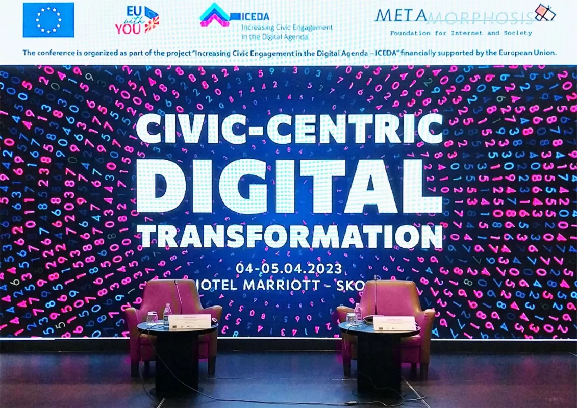 Stage setup for a conference on "Civic-Centric Digital Transformation" with chairs and a backdrop.