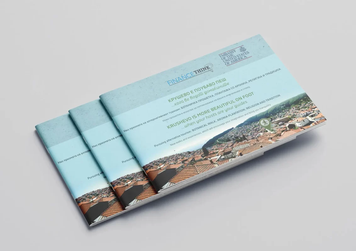 Stack of blue brochures with an aerial city view on the cover.