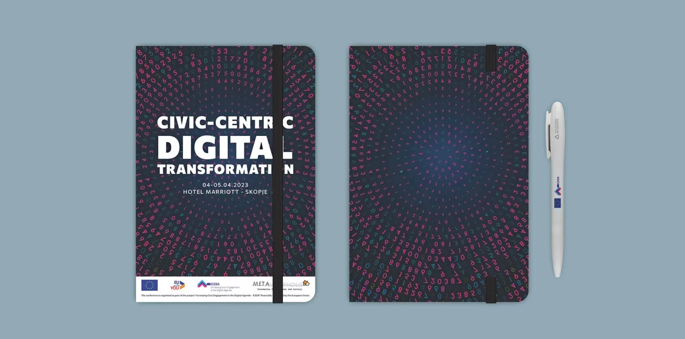 Brochure and notebook with abstract design for a digital transformation event, beside a pen.