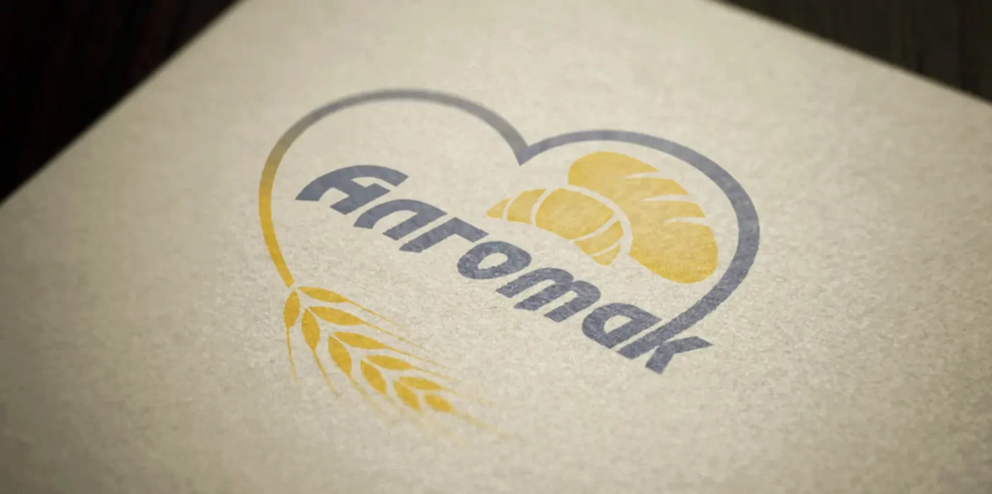 Algomak logo on textured paper.