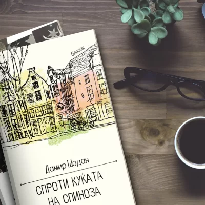 Desk with a book, eyeglasses, coffee cup, and plant on a wooden background.