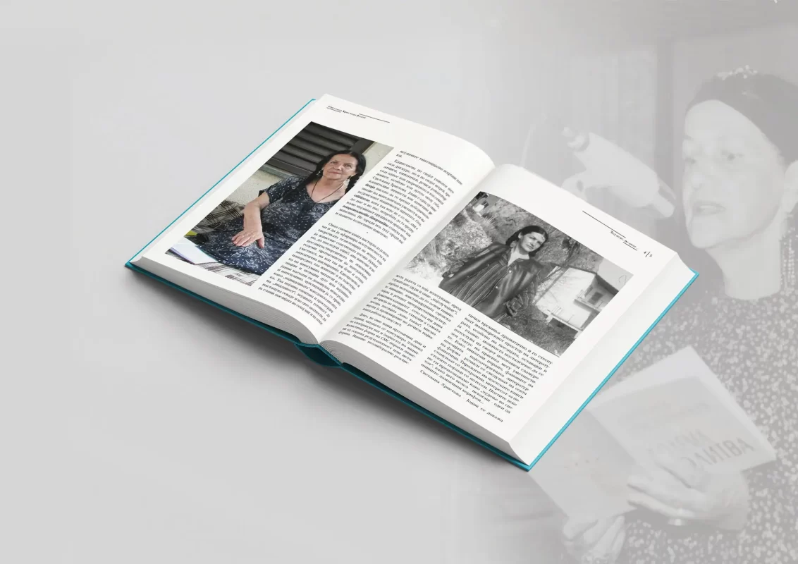 An open magazine with text and monochrome photos on a reflective surface.