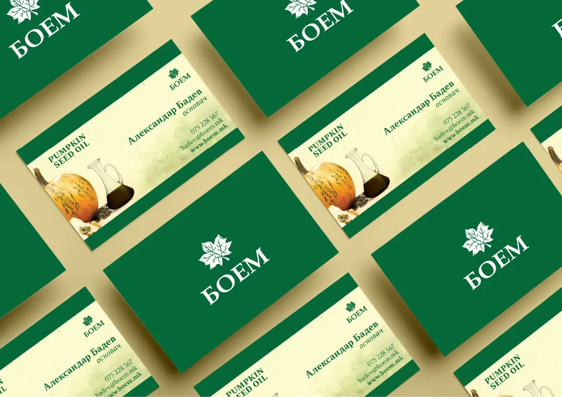 Multiple business cards with green design, featuring pumpkin seed oil products.