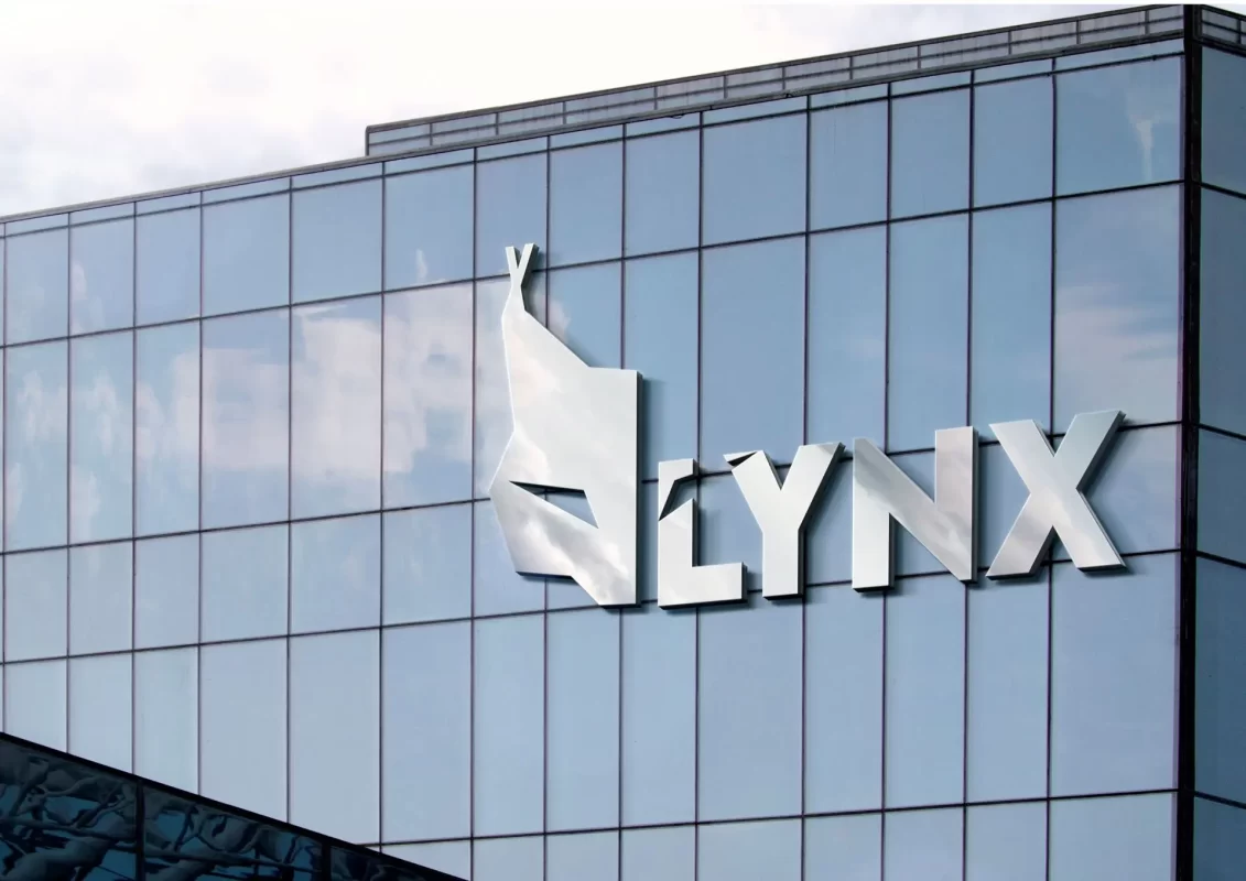 Logo with stylized lynx figure and "LYNX" text on a glass building façade.