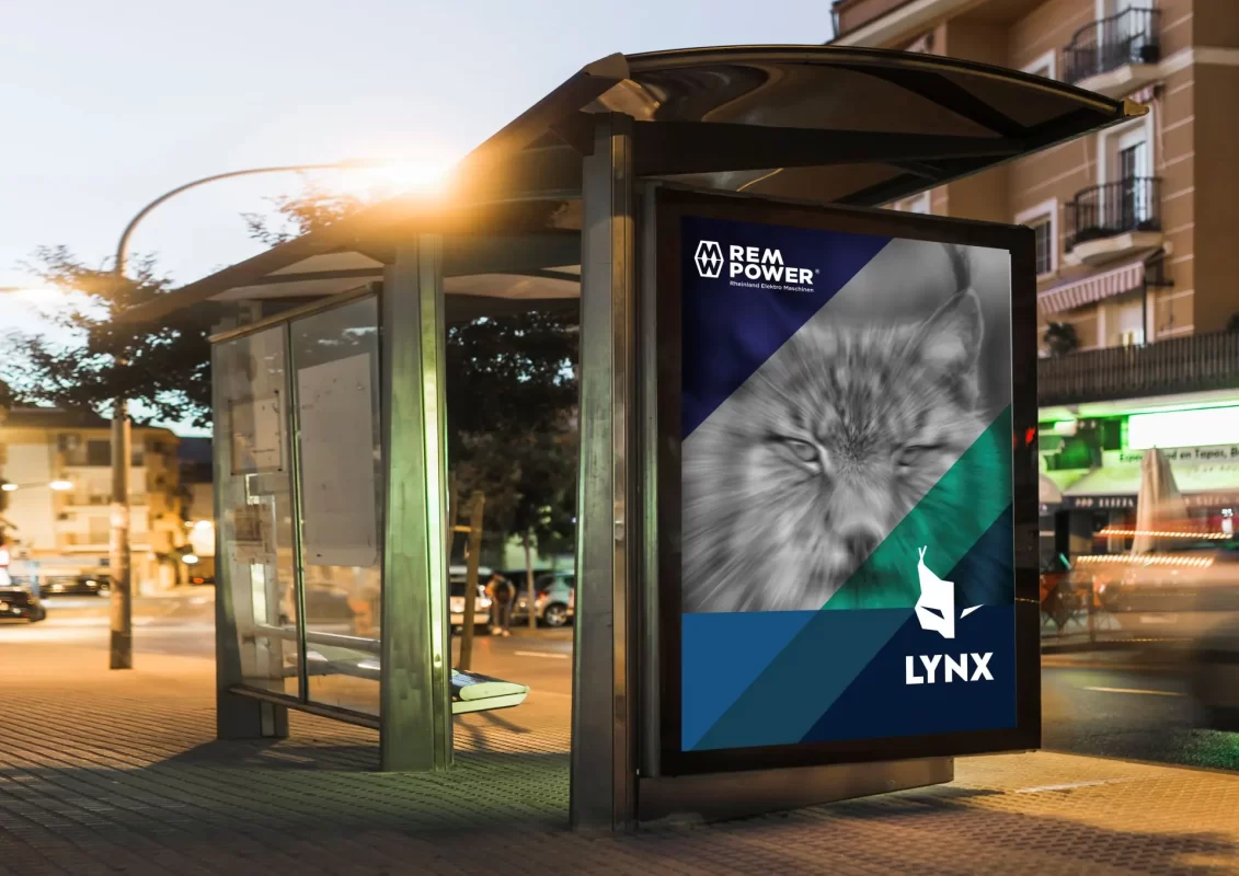 Bus stop at twilight with an illuminated ad featuring a graphic design of a lynx.