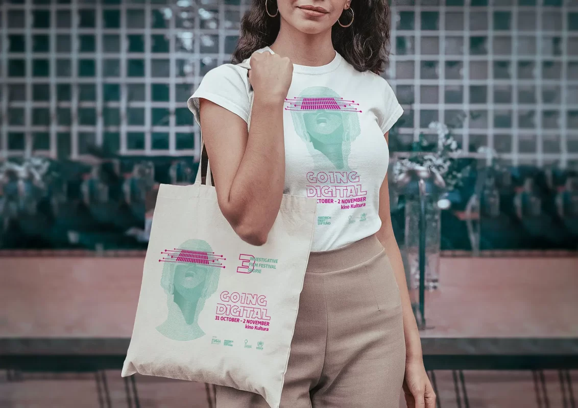 Woman holding a tote bag with the same design as her T-shirt, reading "GOING DIGITAL".