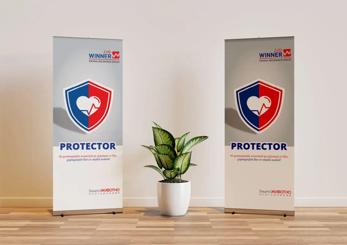 Two roll-up banners with "PROTECTOR" text next to a potted plant on a wooden floor.